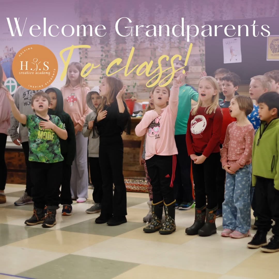Students singing together with raised hands